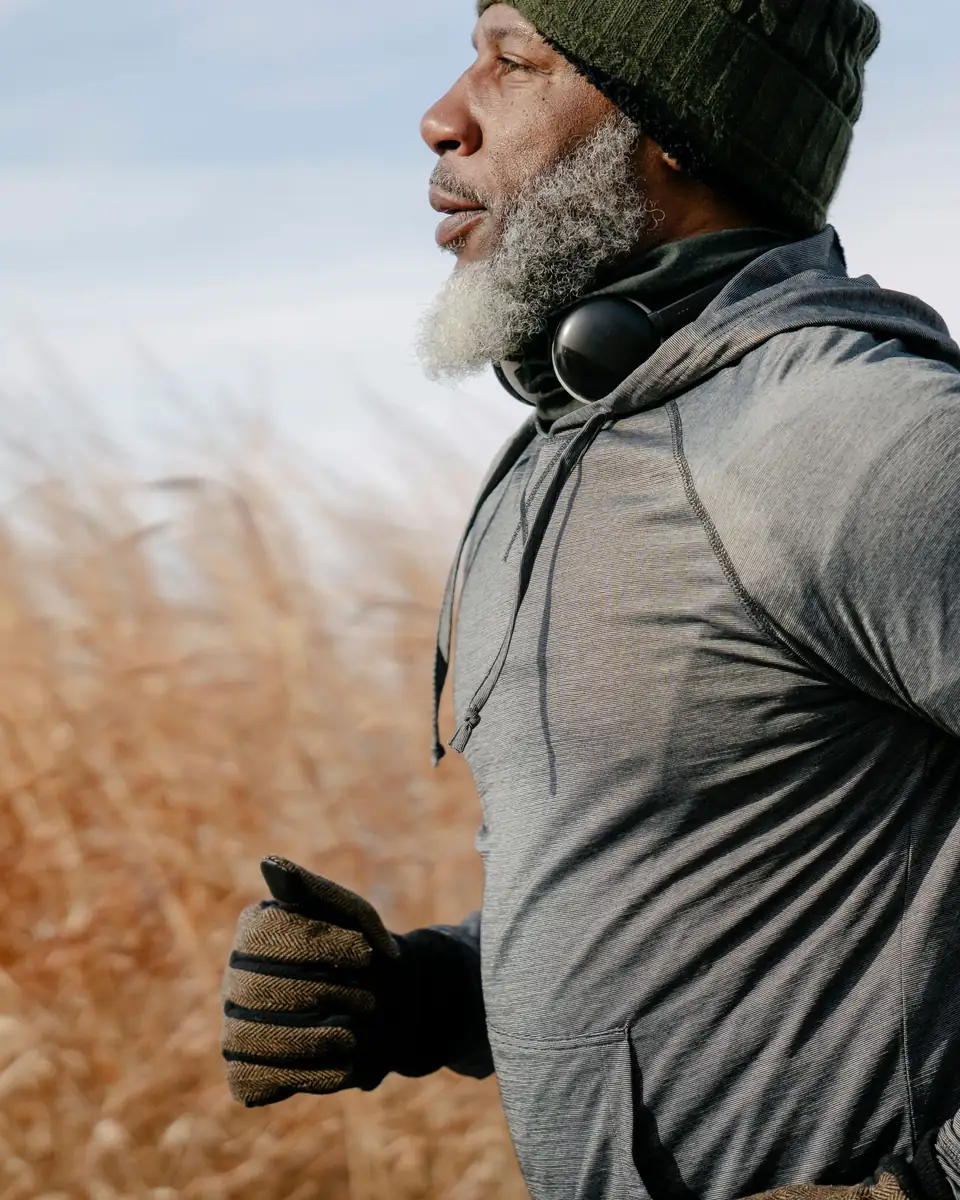 Fit man in his fifties running outdoors in winter sun